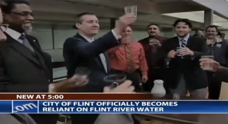 Officials toasting to the use of Flint’s river. Photo: YouTube